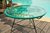 Zipolite Round Table made of black steel, coloured PVC rope and glass table.